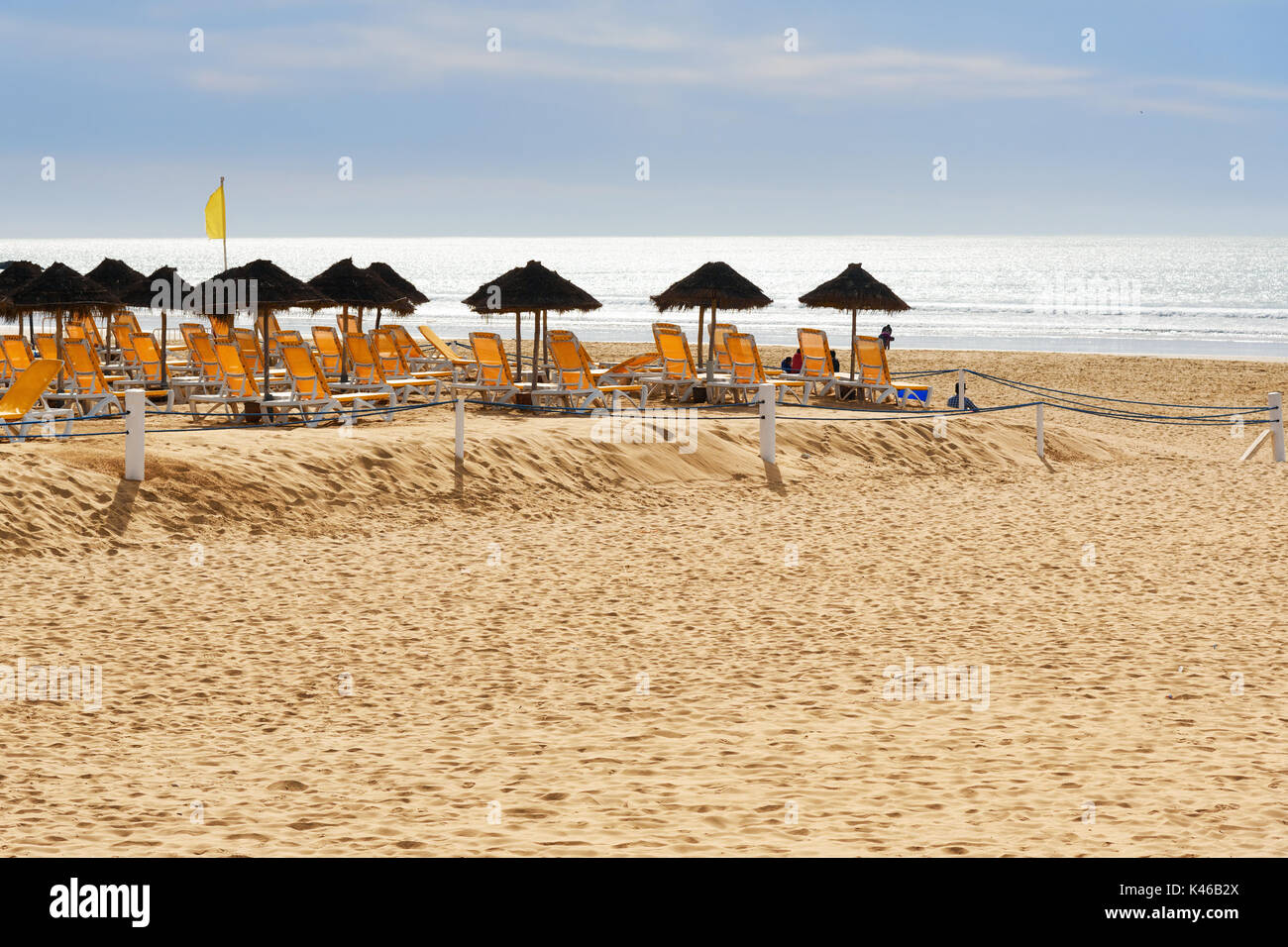 Umbrellas and chaise lounges on beach in Agadir. Morocco Stock Photo