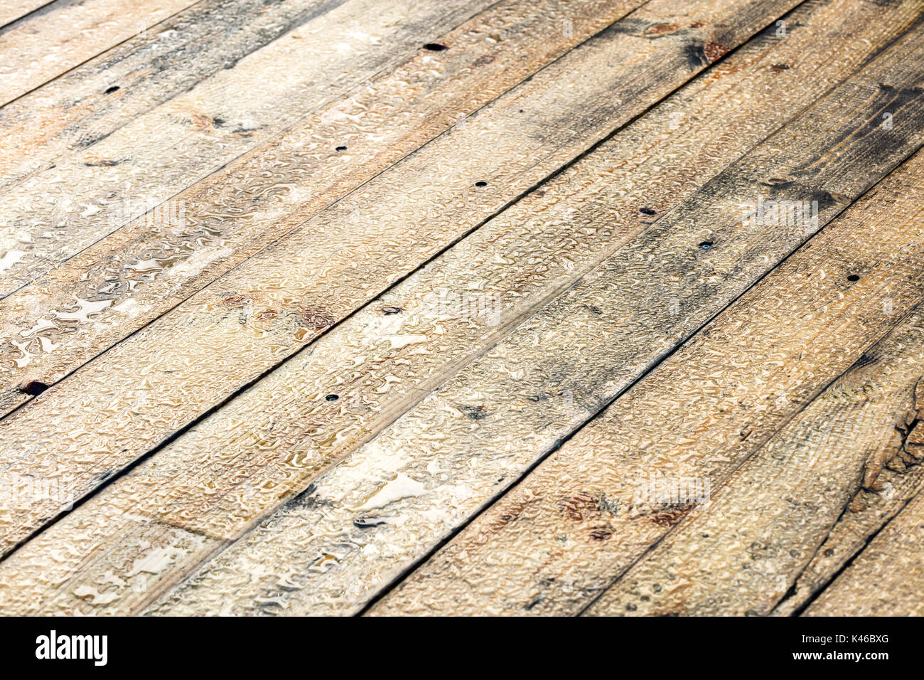 wet cottage deck after summer rain. raindrops on wooden planks. Stock Photo