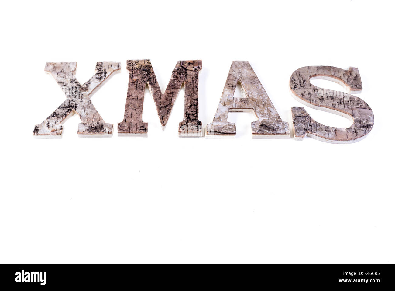 birch bark letters forming the word XMAS isolated on white Stock Photo