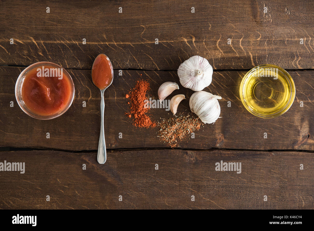 top view of tomato sauce with olive oil and garlic with species on