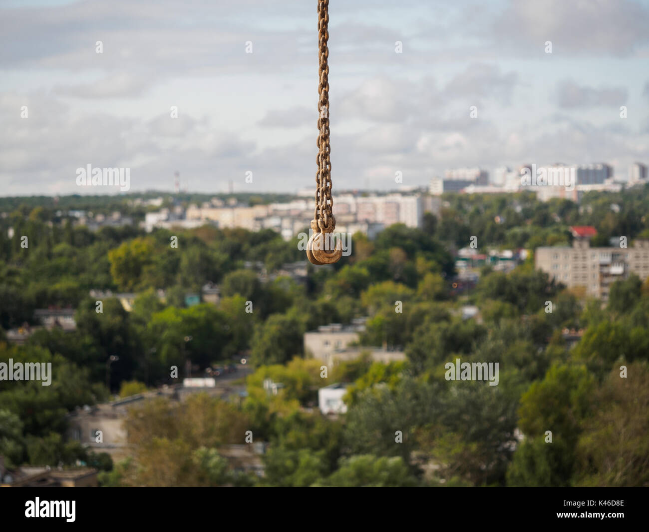 small rusty crane hook on background city view Stock Photo