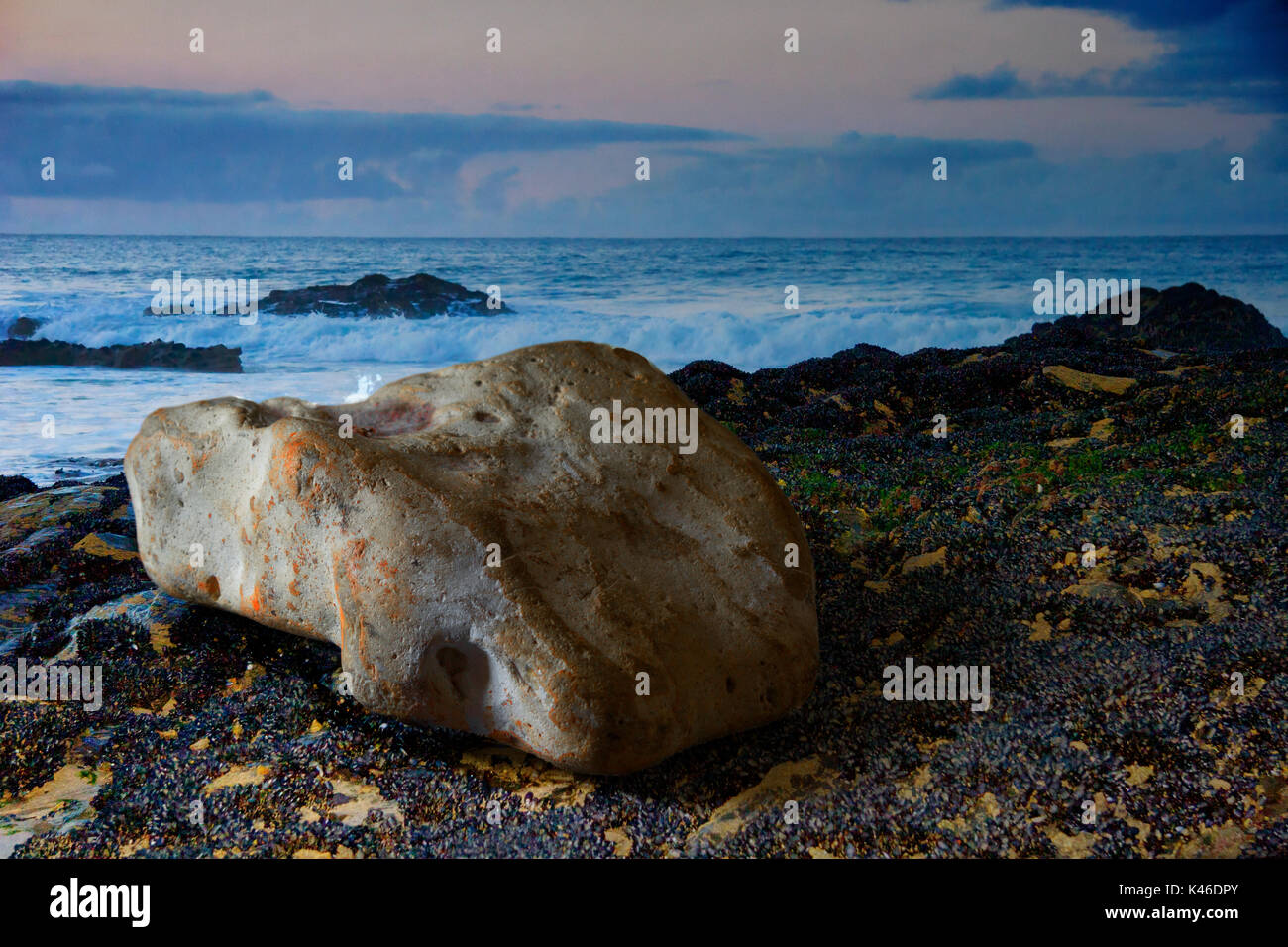 Colourful stone on a beach at sunset Stock Photo