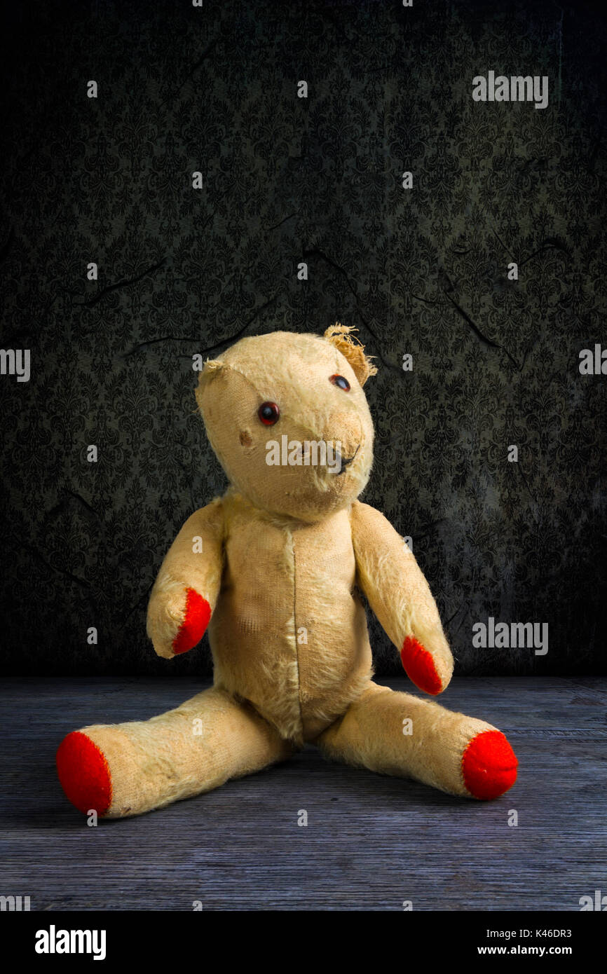 Old threadbare and dishevelled teddy bear doll. Stock Photo