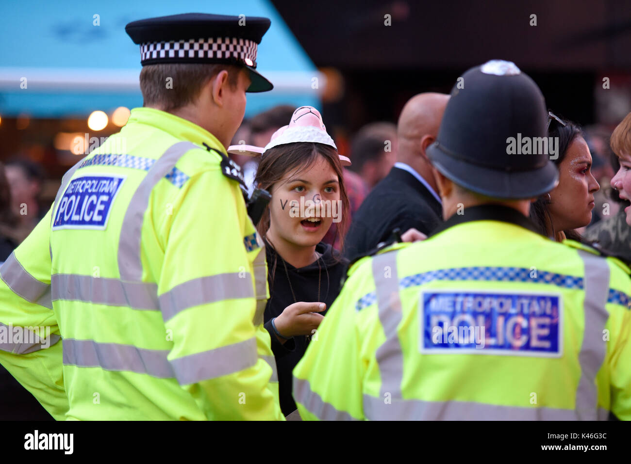 Metropolitan police asking a vegan animal rights activist to move along in Leicester Square, London, UK. Space for copy Stock Photo