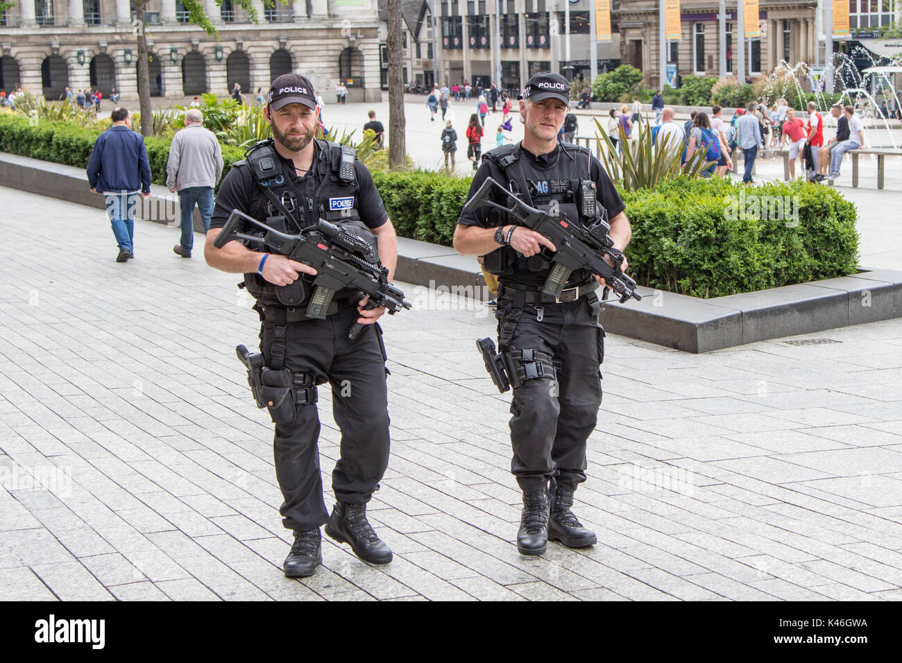 Two male armed police offcers patrol Nottingham's Old Market Square Stock Photo