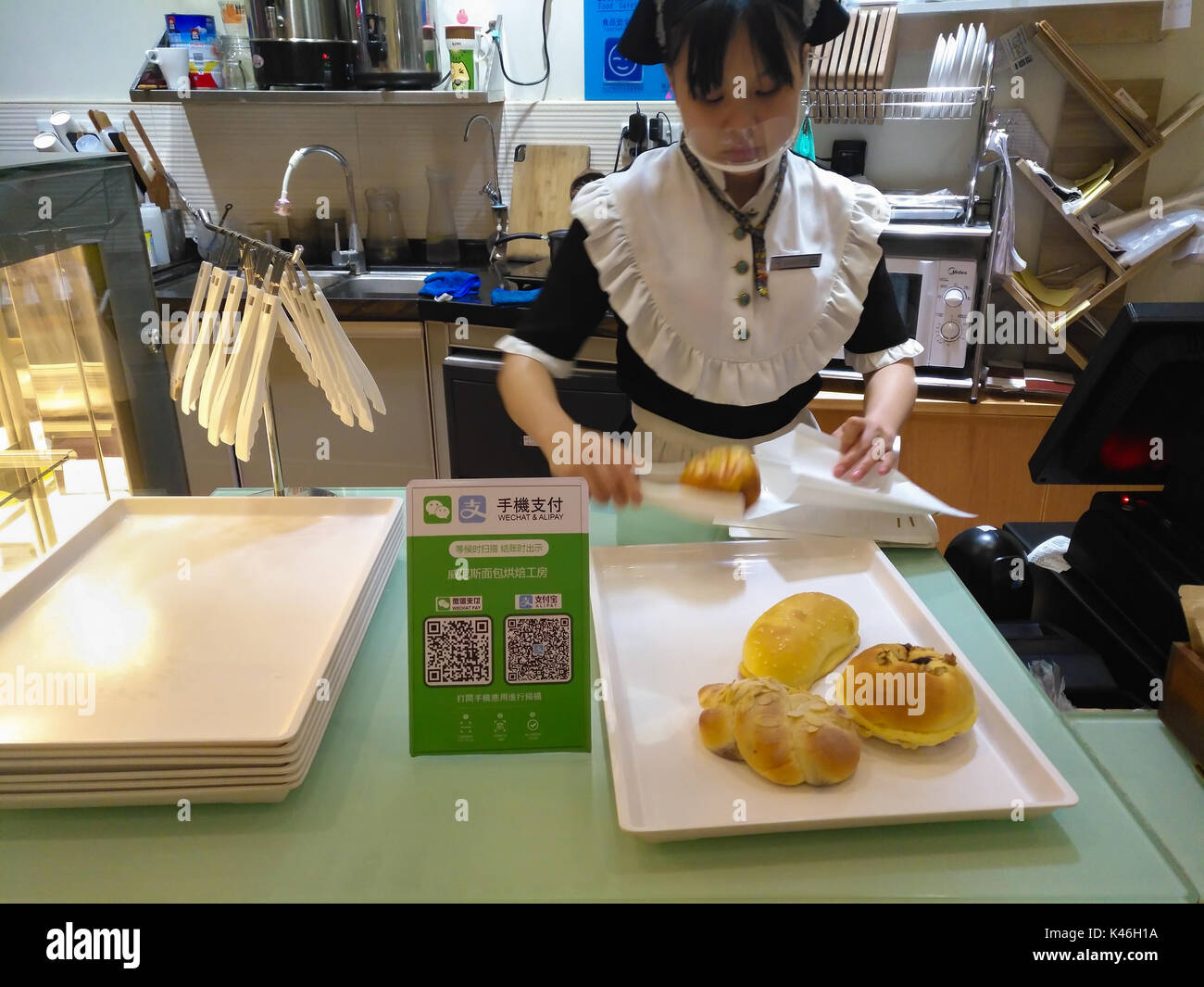 Zhongshan,China-August 26, 2017:buying bread with payment via QR code of Wechat or Alipay.QR code for payment and money transfering becomes very commo Stock Photo