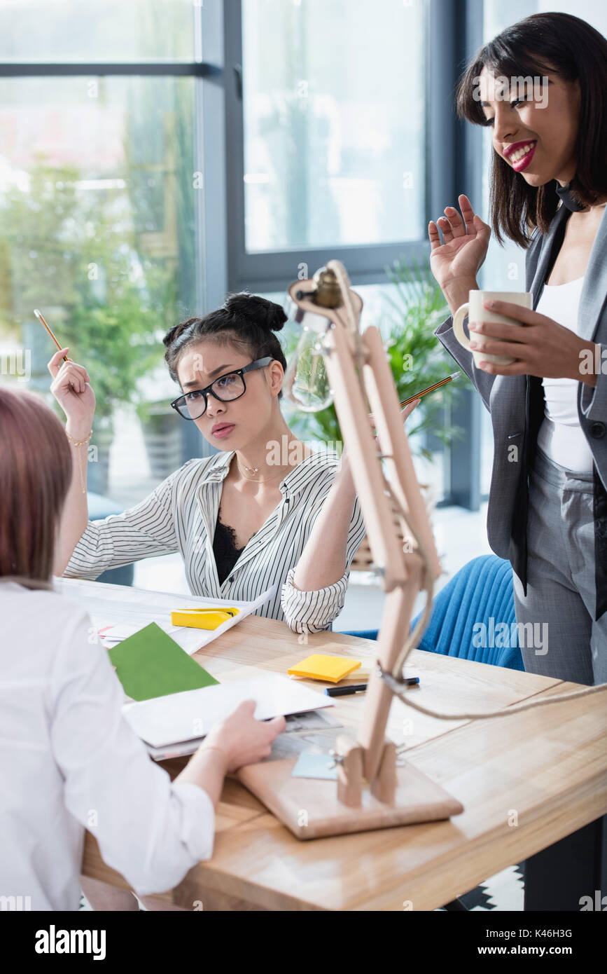 Professional young businesswomen working together in modern office and ...