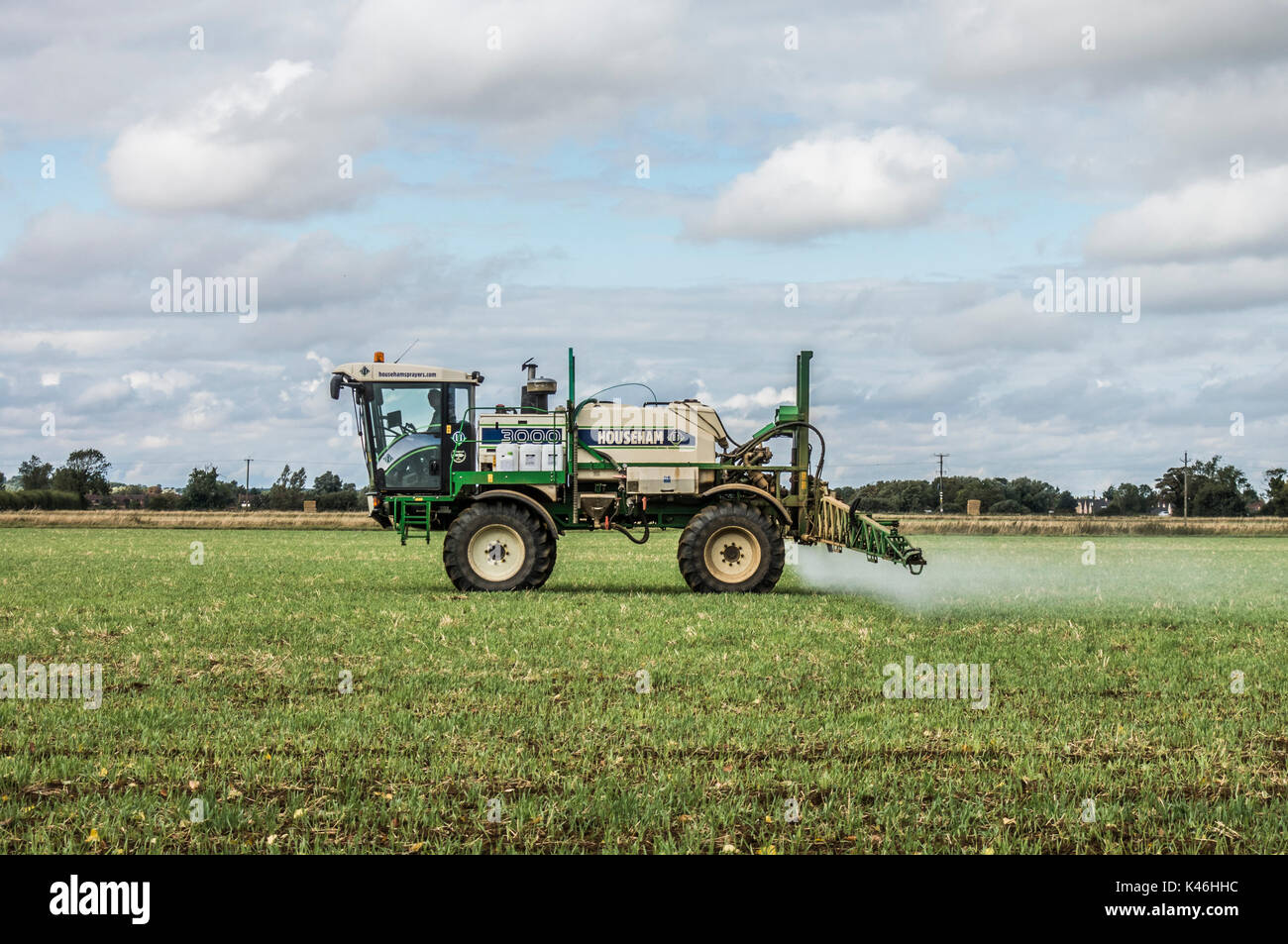 Man driving a Househam 300 crop sprayer in a recently harvested field, in the early autumn. Langtoft, Lincolnshire, England, UK. Stock Photo