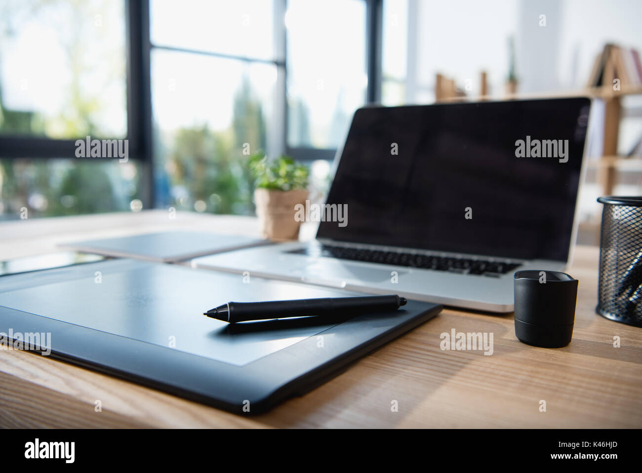 laptop with blank screen and graphics tablet on wooden tabletop at office Stock Photo