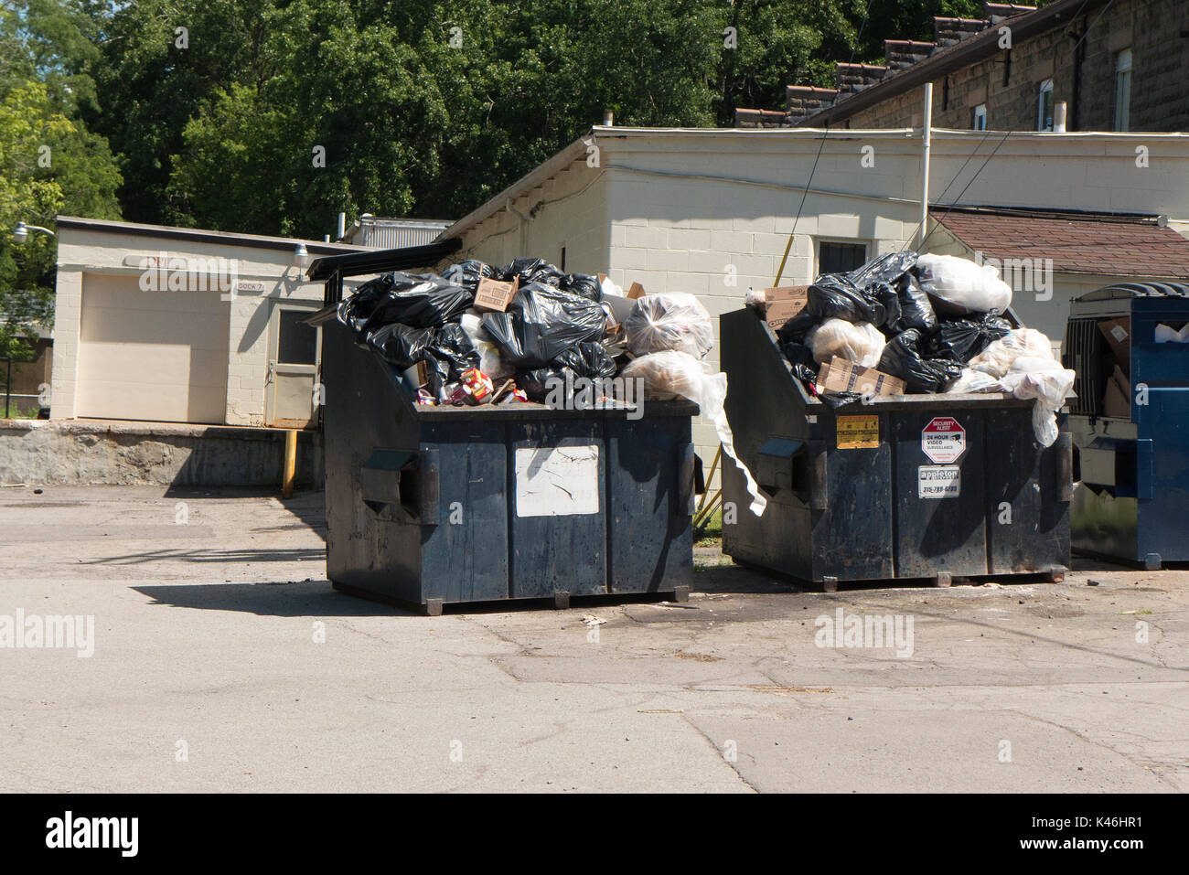 Overflowing trash dumpsters Stock Photo Alamy