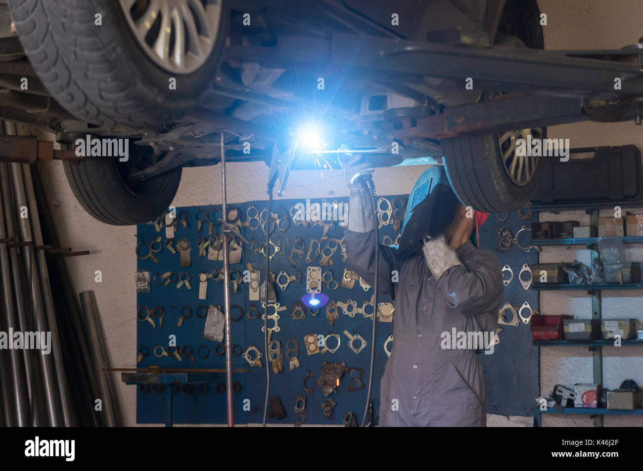 Welding seams on steel exhaust pipe in garage Stock Photo Alamy