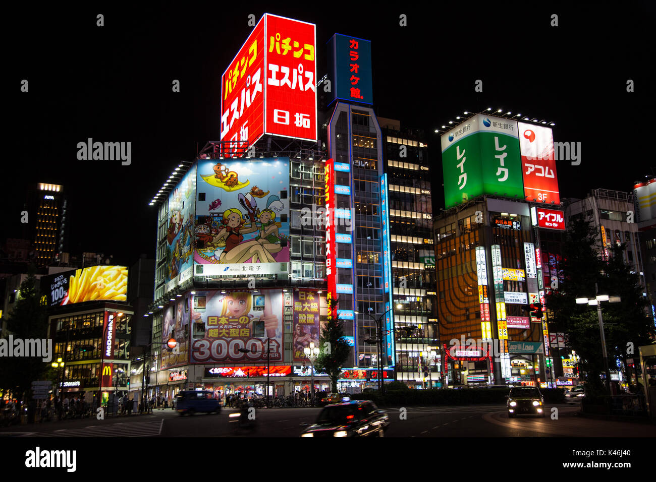 Shinjuku area of Tokyo at night with its neon lights trying to draw in local and tourist business. Stock Photo