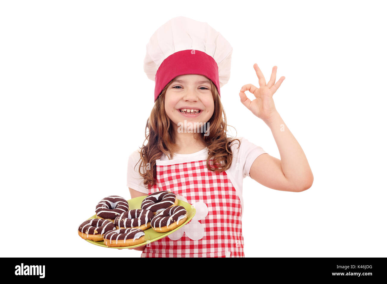 happy little girl cook with chocolate donuts and ok hand sign Stock Photo