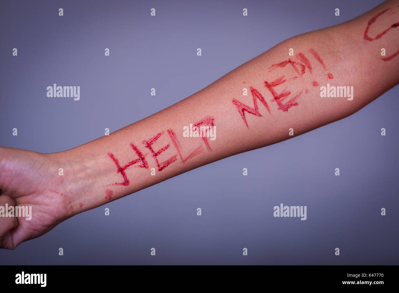Close up of a young depressive woman, with her arm bleeding with the help  word written in her arm with a knife, in a blurred background Stock Photo -  Alamy