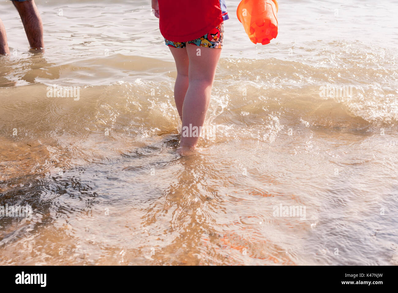 Young boy's legs in the sea. Southend-on-Sea, Essex, UK. Stock Photo