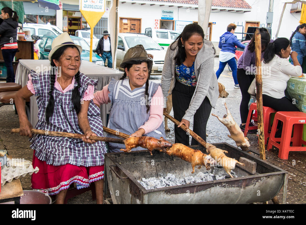 Gualaceo, Ecuador - Mar 13, 2016: Vendors prepare cuy (guinea pig) for lunch Stock Photo