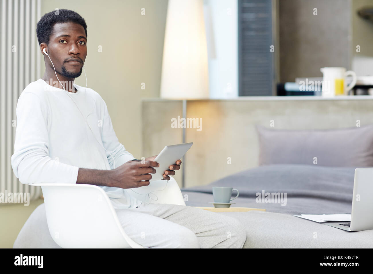 Young afro american man sitting hi-res stock photography and images - Alamy