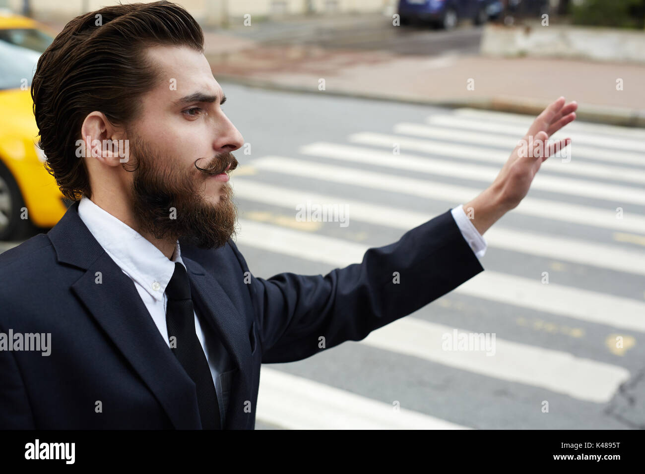 Waving hand for taxi Stock Photo
