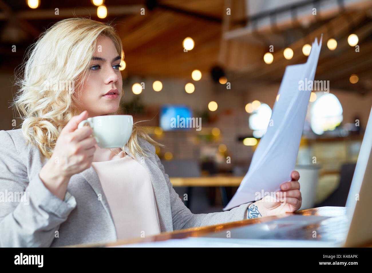 Studying Documents at Coffeehouse Stock Photo