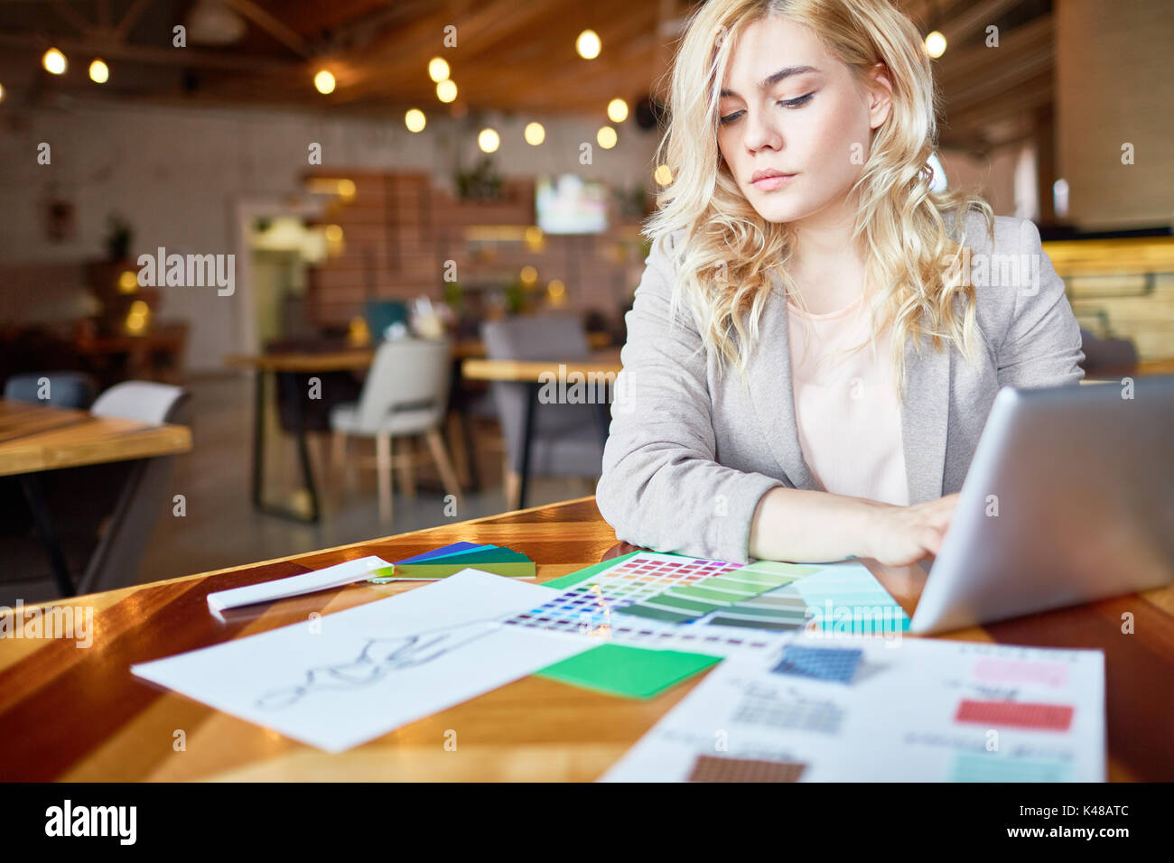 Pensive Fashion Designer Focused on Work Stock Photo