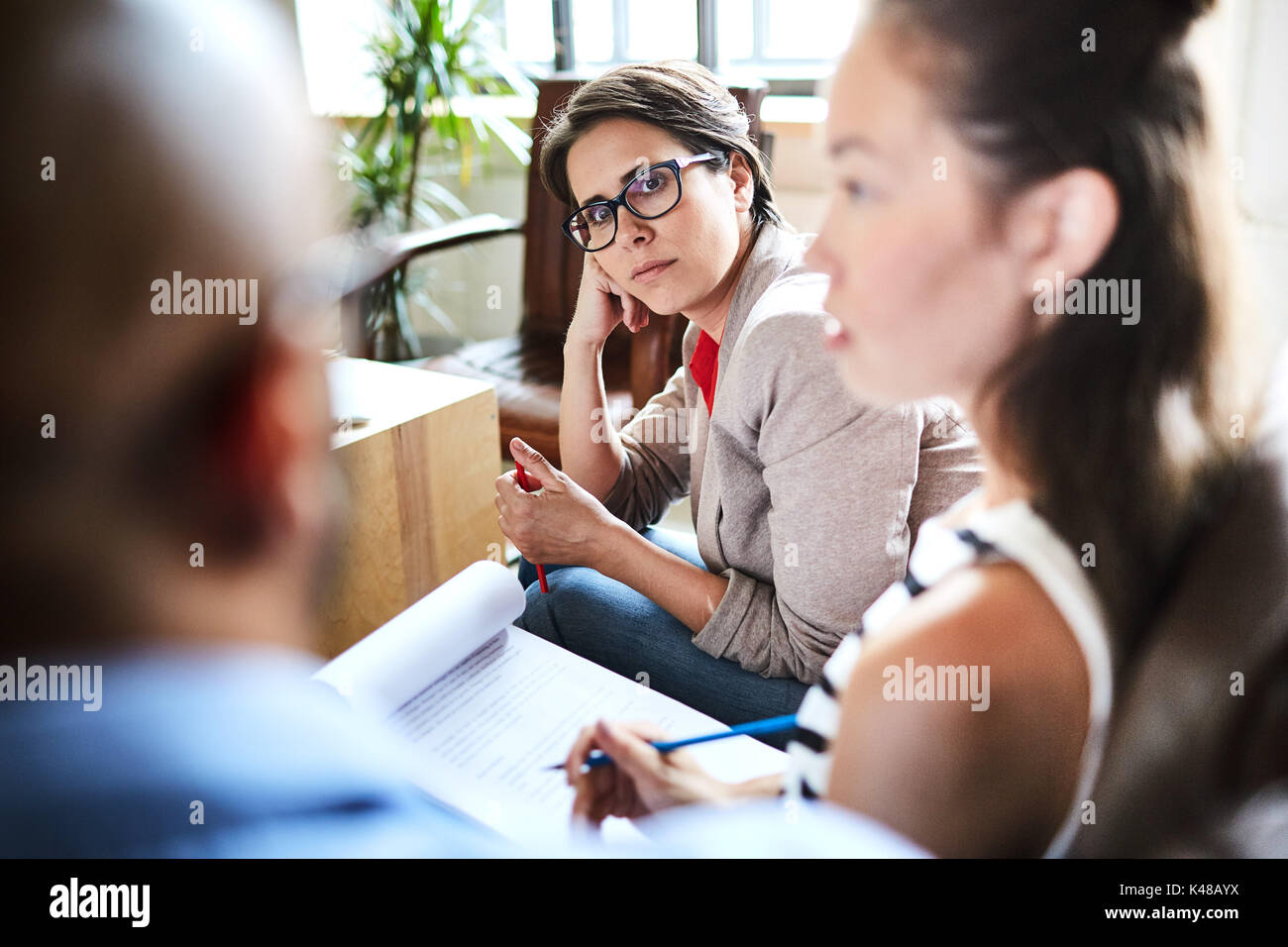 Analyzing Financial Figures with Coworkers Stock Photo
