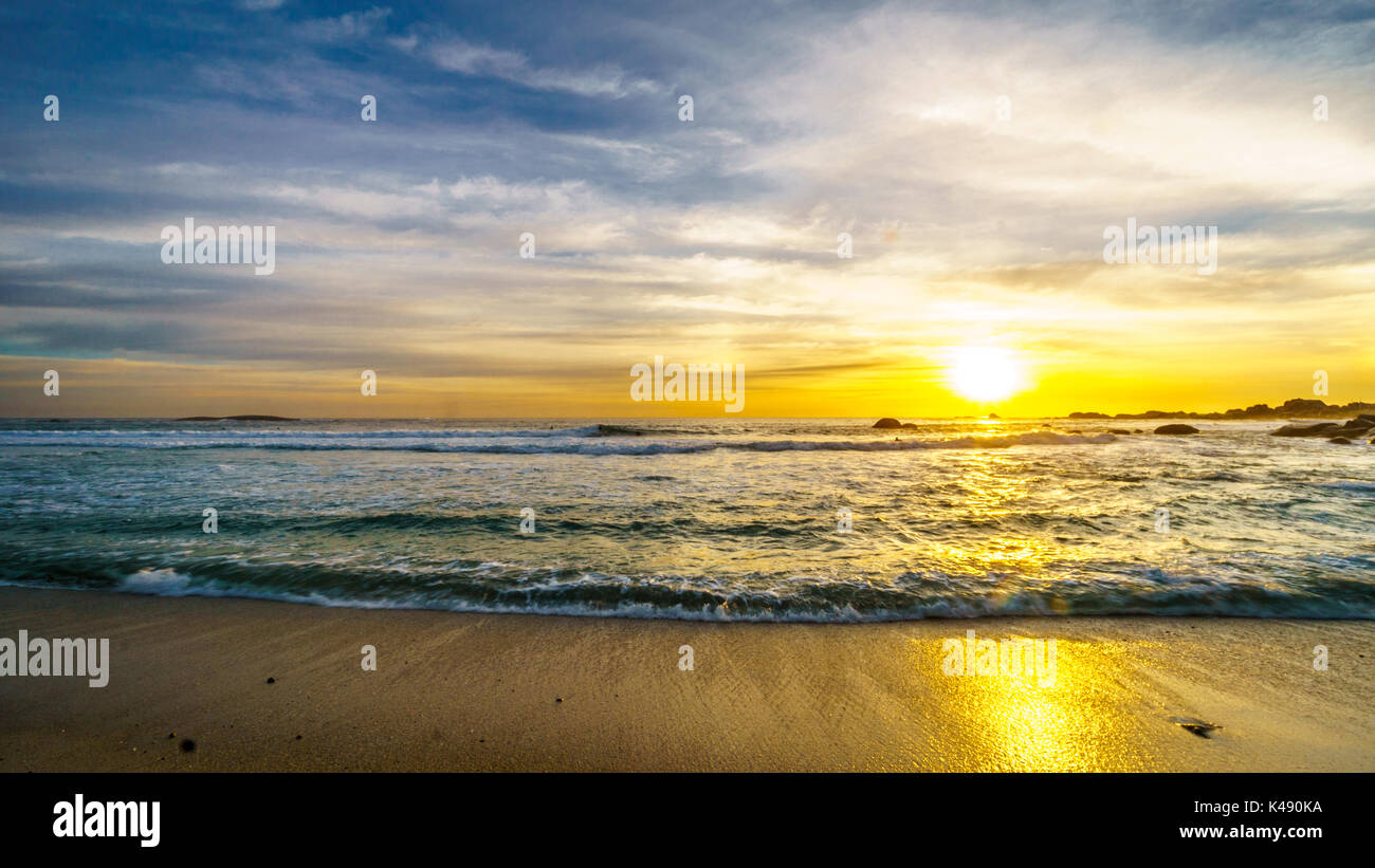 Sunset over the horizon of the Atlantic Ocean at Camps Bay near Cape Town South Africa on a nice winter day Stock Photo