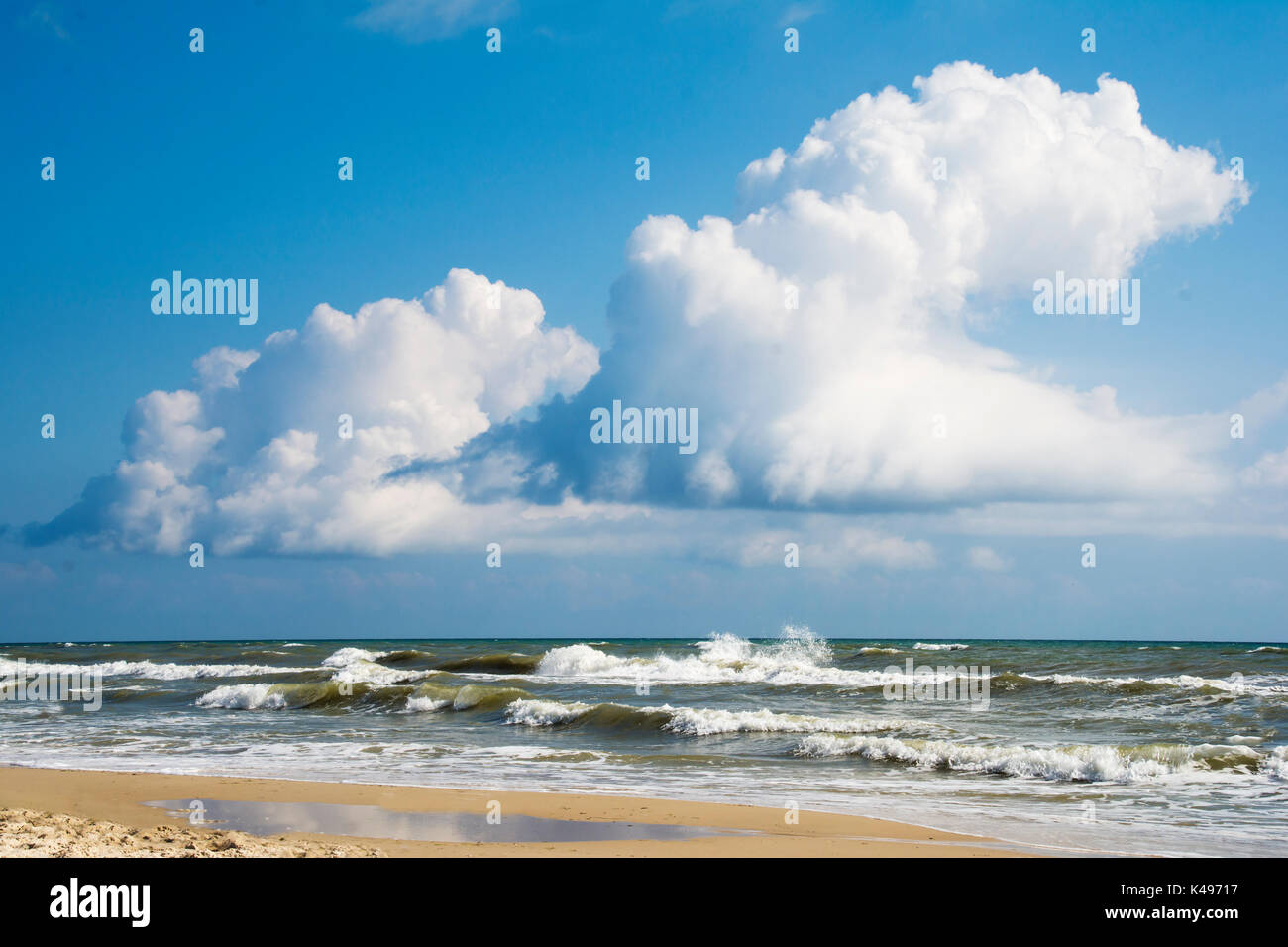 Bright blue sky with clouds over stormy sea Stock Photo - Alamy