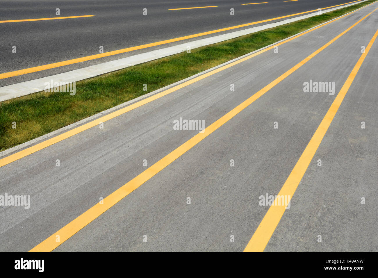Detail of a road with yellow lines Stock Photo Alamy