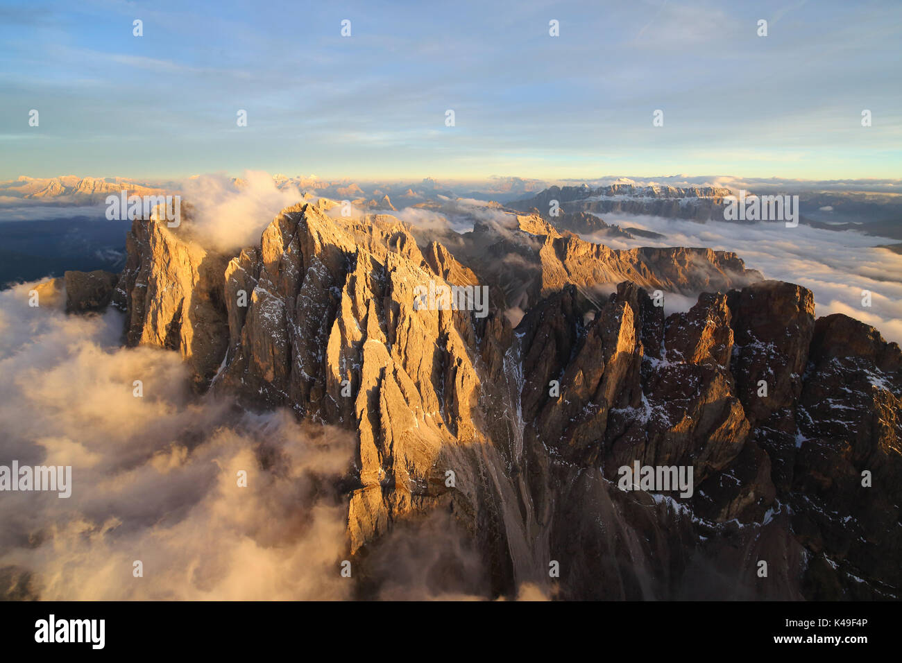 Aerial view of the mountain range of Odle surrounded by clouds. Dolomites Val Funes Trentino Alto Adige South Tyrol Italy Europe Stock Photo