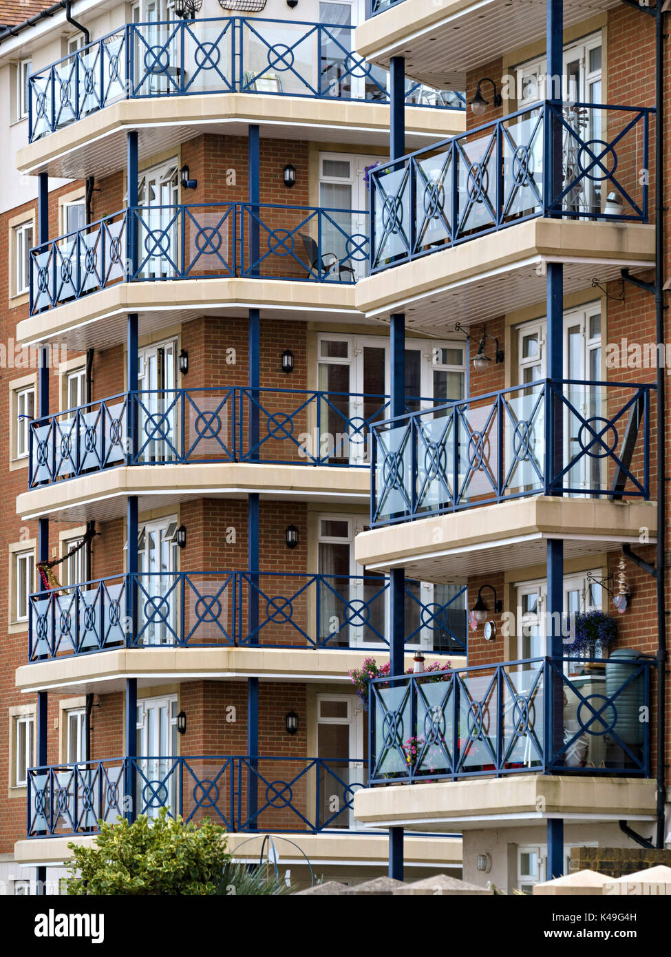 Modern flats and apartments with blue painted metal railings and balconies, Sovereign Harbour, Eastbourne, East Sussex, England, UK. Stock Photo