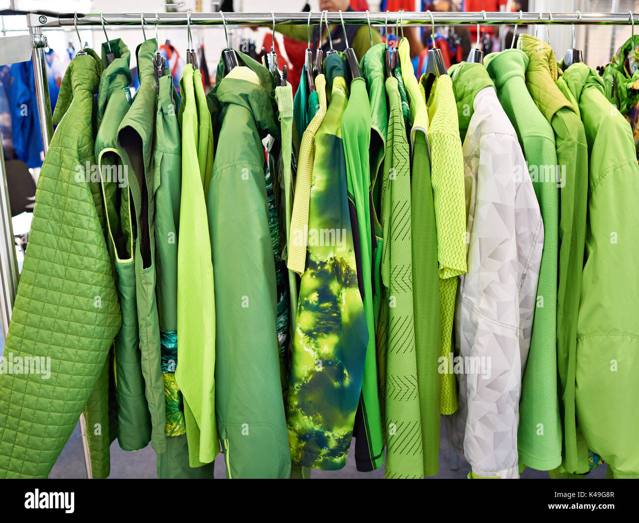 Jackets, waistcoats and rainwear on a hanger in the store Stock Photo