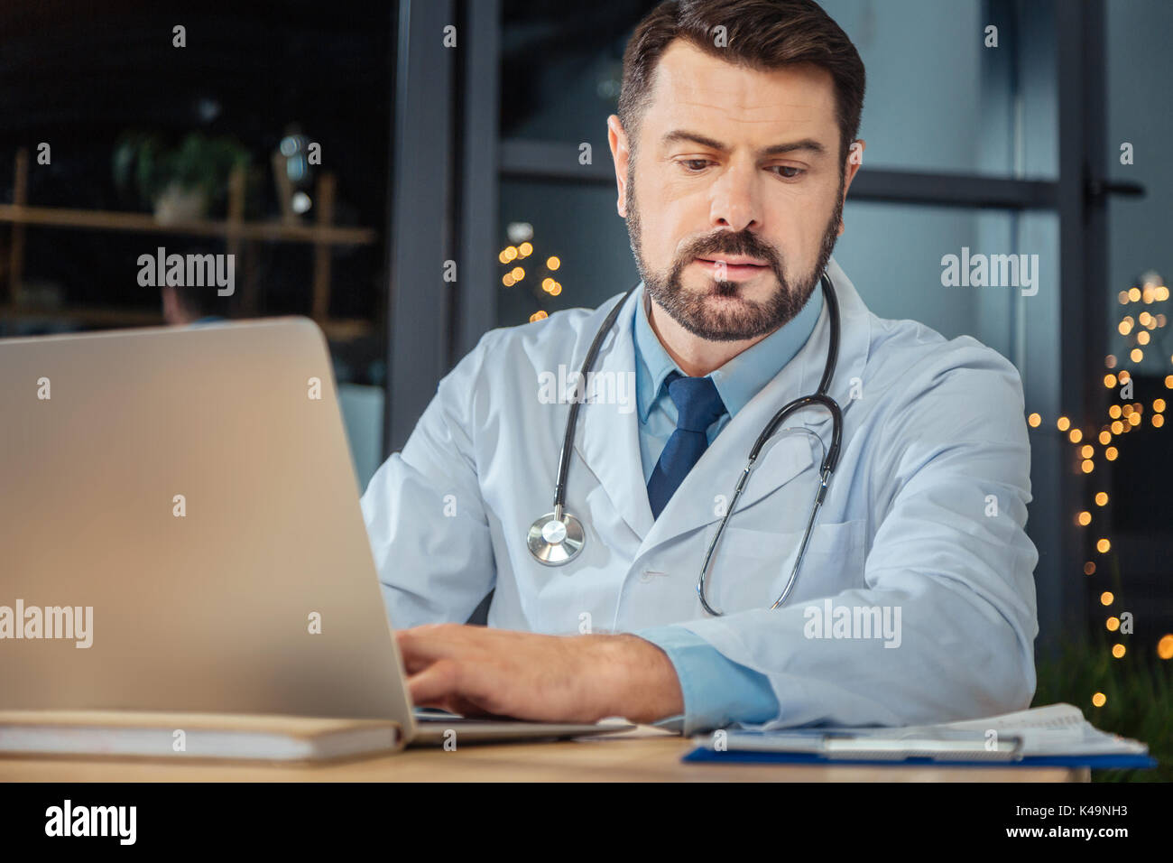 Serious hard working scientist using a laptop Stock Photo