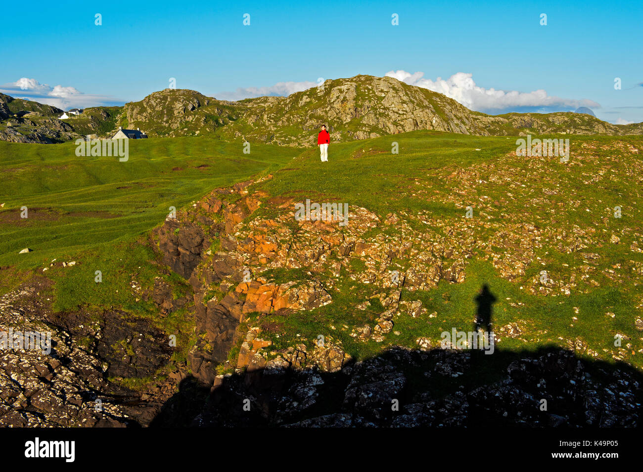 Woman In A Red Jacket Standing On Rocky Meadow, Assynt, Scotland, Great Britain Stock Photo