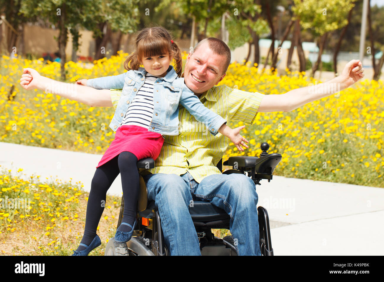Disabled father showing freedom with little daughter. Stock Photo