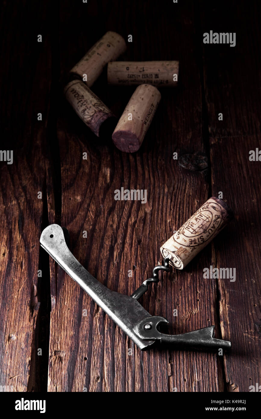 Old Corkscrew With Cork On Wooden Background Stock Photo