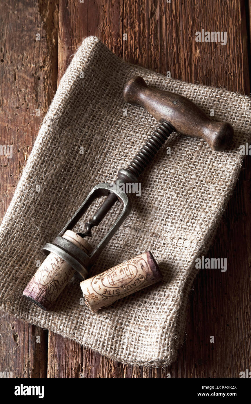 Old Corkscrew With Cork On Wooden Background Stock Photo