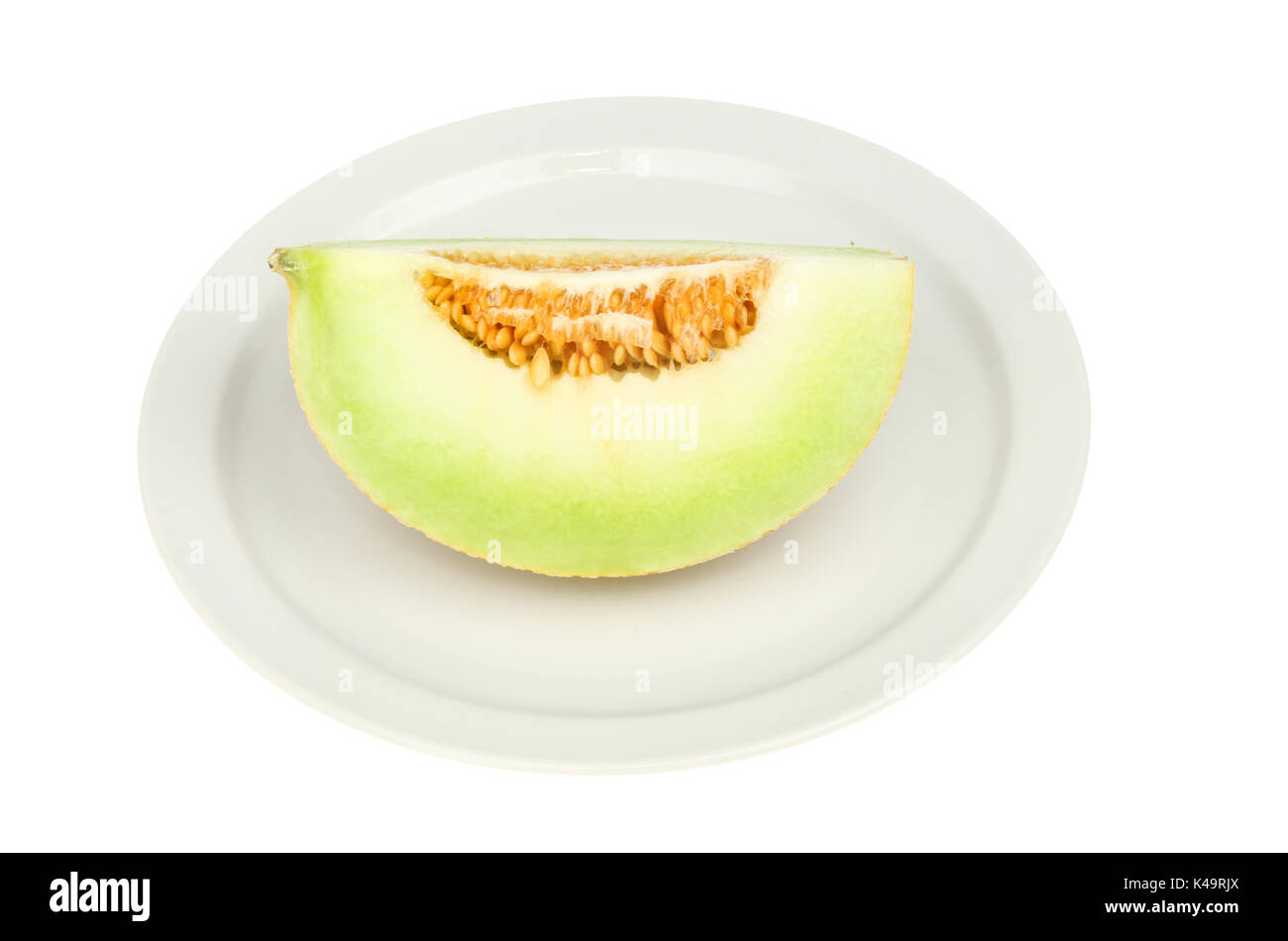 galia melon portion on a plate isolated against white Stock Photo