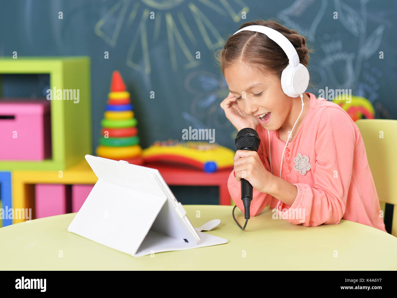 Little girl singing karaoke Stock Photo Alamy