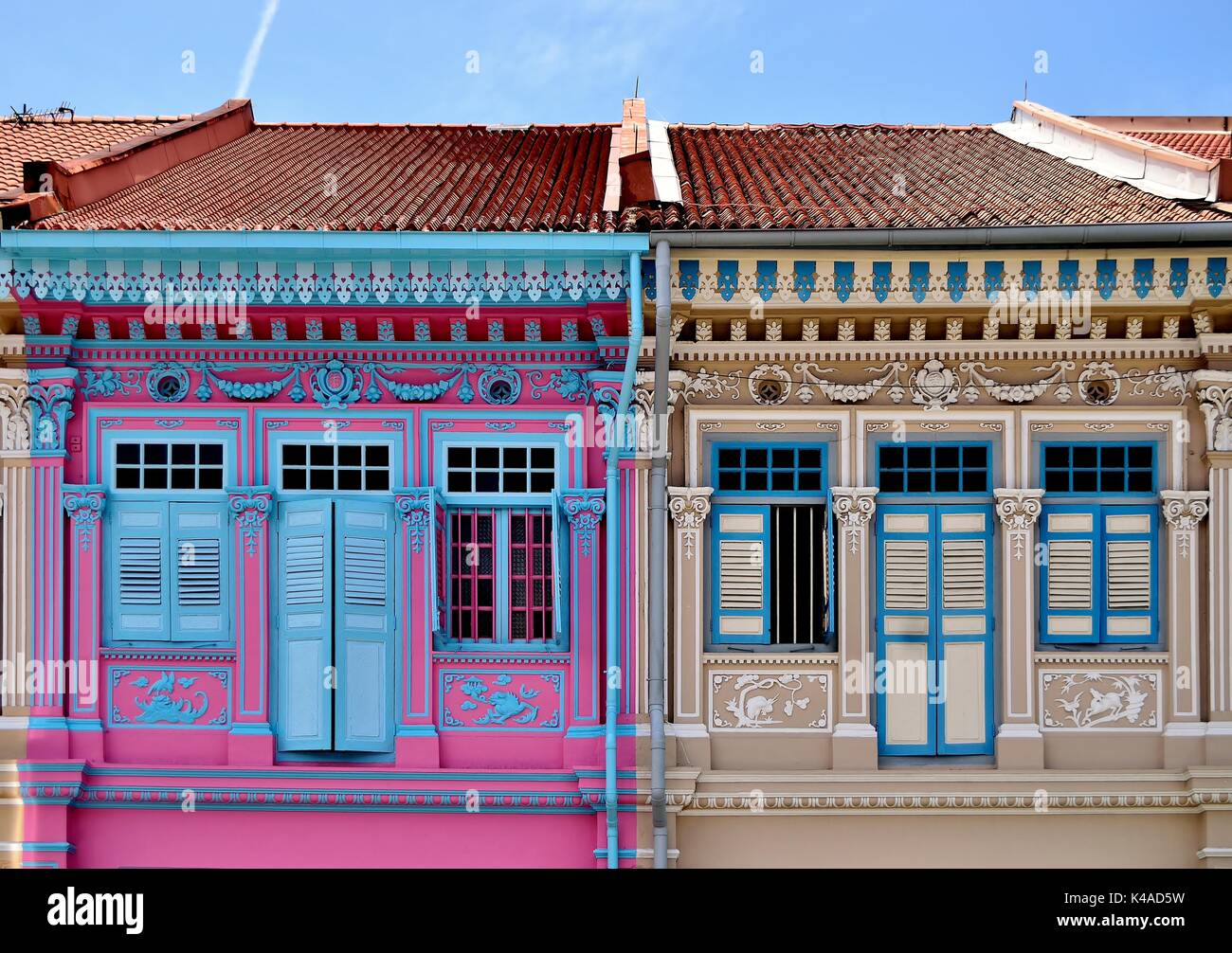 Traditional shop house exteriors with wooden louvered shutters and  ornate columns and carvings in the Joo Chiat District of Singapore. Stock Photo