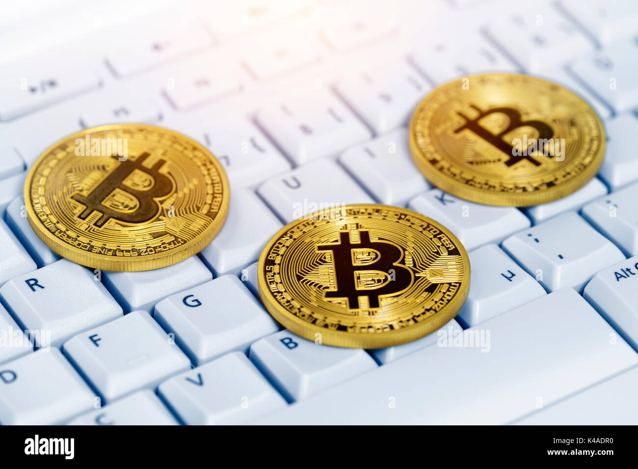 Bitcoins On Computer Keyboard, Virtual Currency Stock Photo