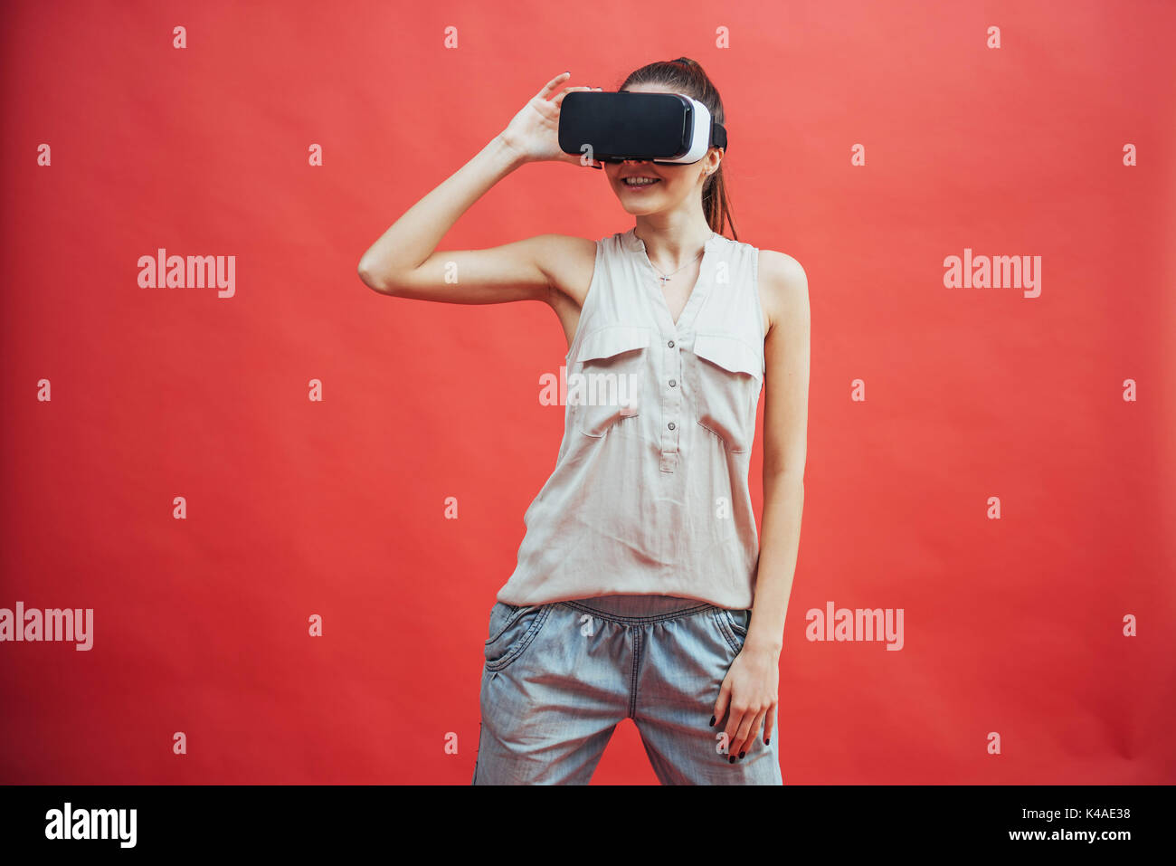 portrait of happy smiling young beautiful girl, gain experience using VR-headset virtual reality glasses, isolated Stock Photo