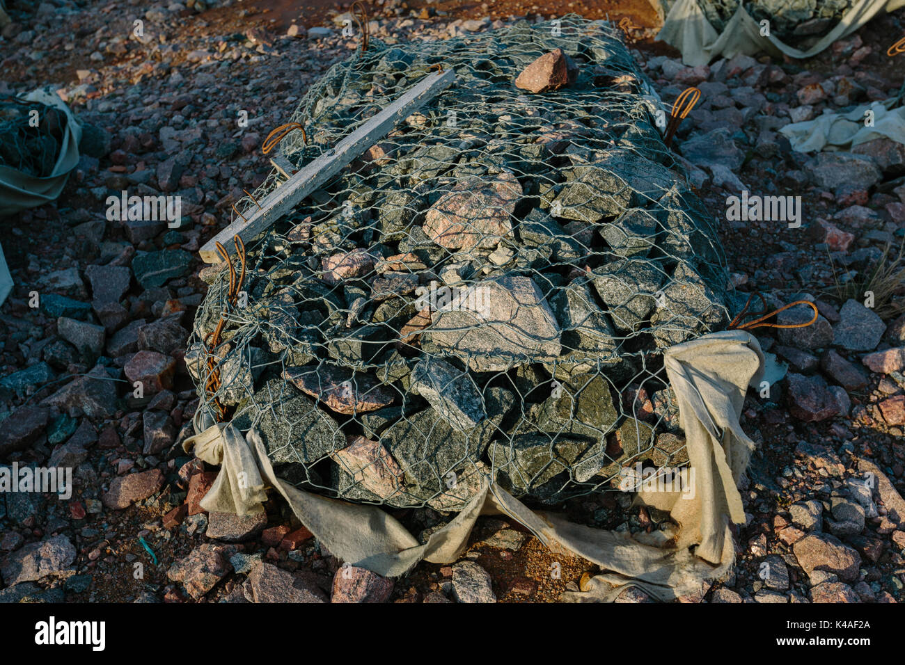 Granite stones in a metal grid Stock Photo