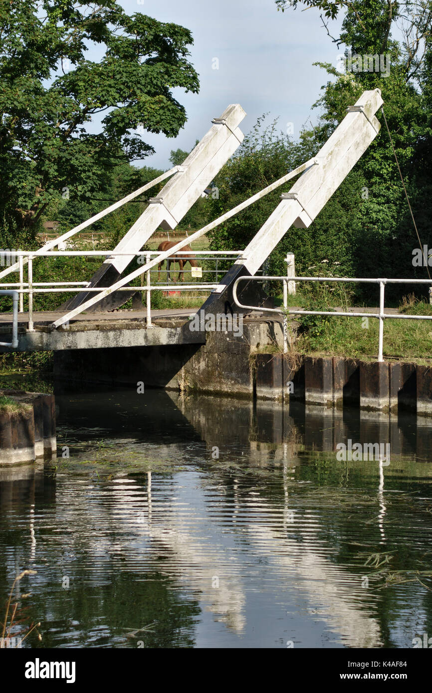 An opening  'bascule' bridge or drawbridge on the Basingstoke Canal near Odiham Castle, Hampshire, UK Stock Photo