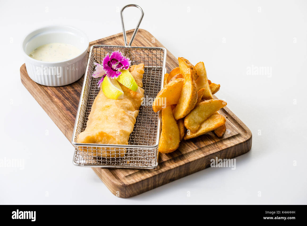 Fried hake fillet in batter with potato wedges and Sauce Tartar Stock
