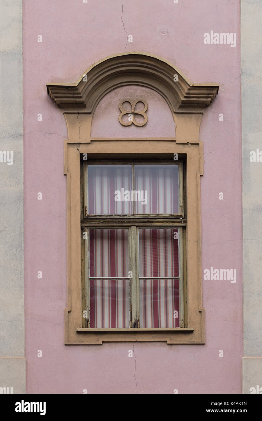 Elegant, decorated window with red and white striped blinds pulled down Stock Photo