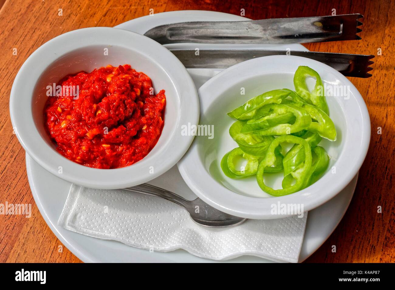 Hungarian Paprika Cream And Green Hot Peppers In Porcelain Dish Stock Photo