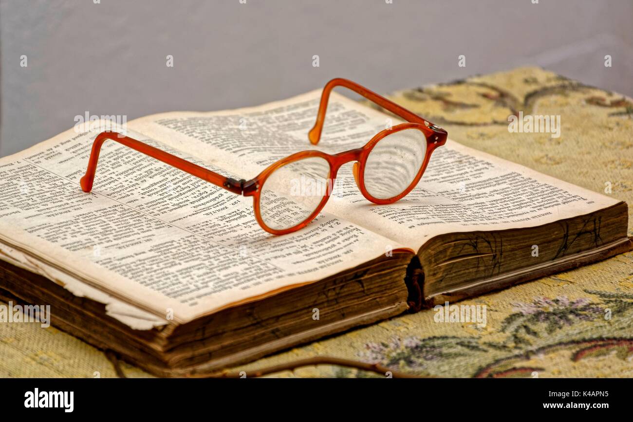 Old Retro Reading Glasses Lie On Old Opened Bible Stock Photo