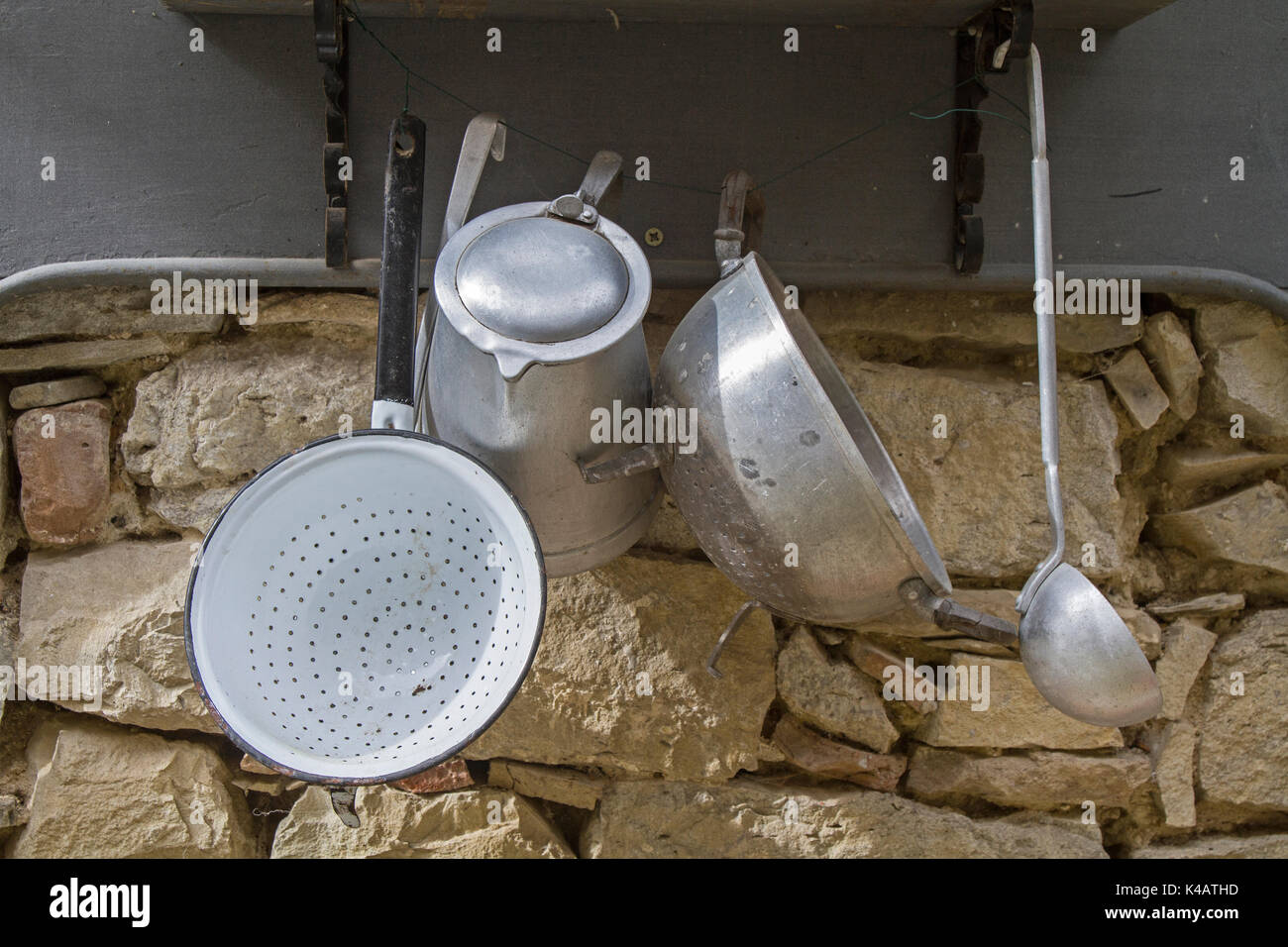 Rustic Cookware On A Stone Wall Stock Photo - Alamy
