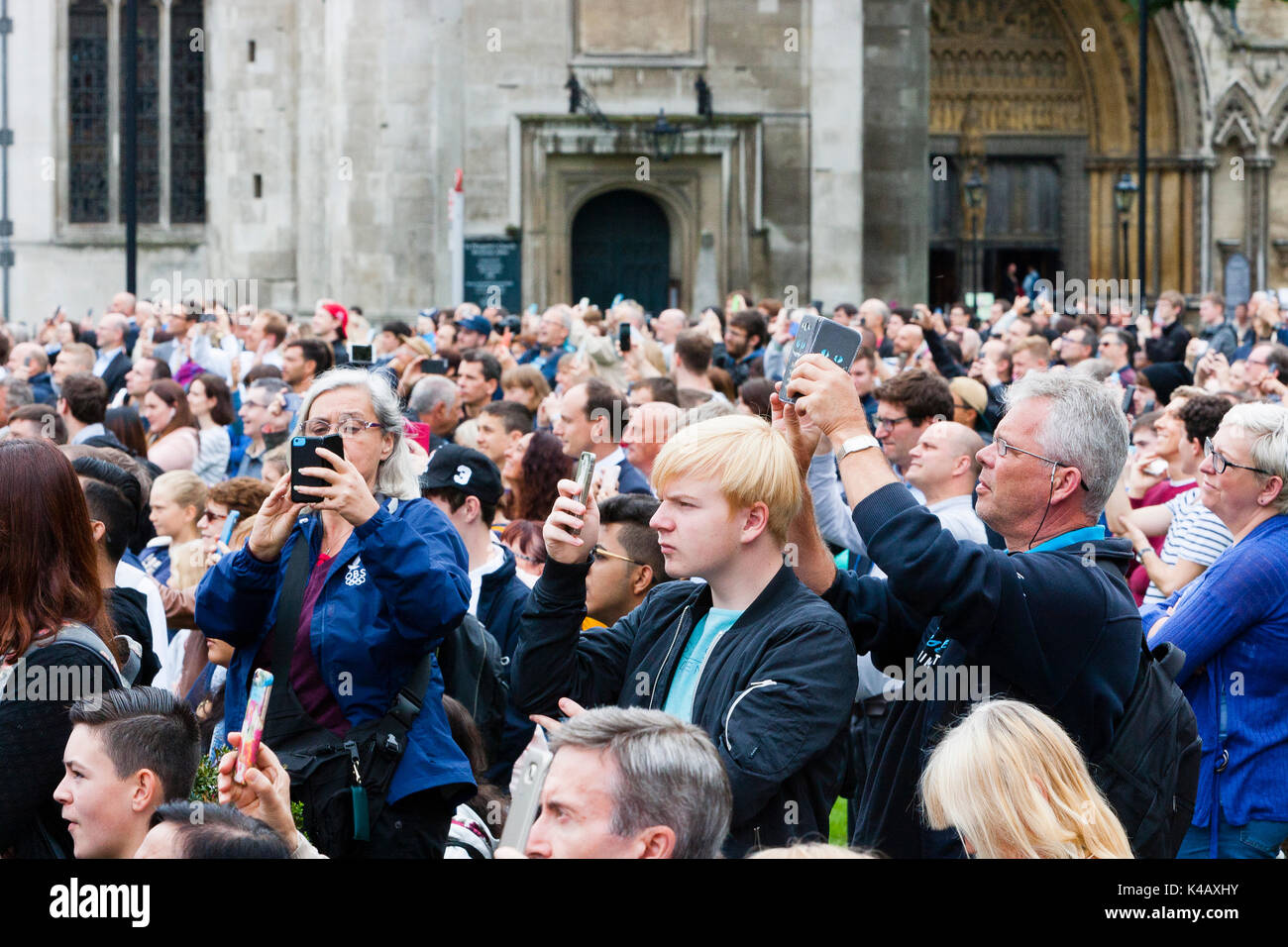 London, UK. Crowds gather to watch and listen to Big Ben fall silent. Stock Photo