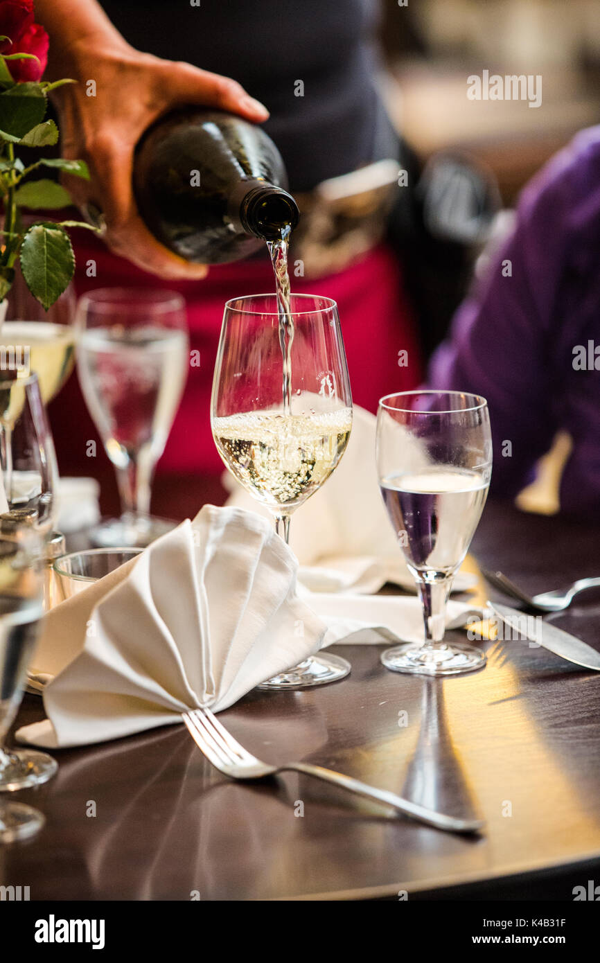 White Wine Is Being Served At A Restaurant Table Stock Photo